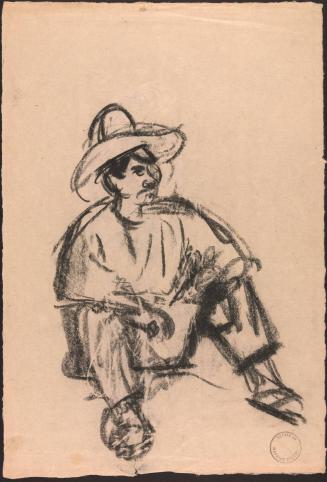 Seated man wearing broad brimmed hat