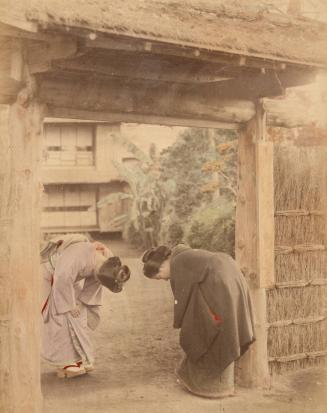 [Two women bowing at doorway]