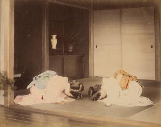 [Two women bowing on a mat]