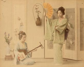 [Woman dancing with fan and woman playing instrument]