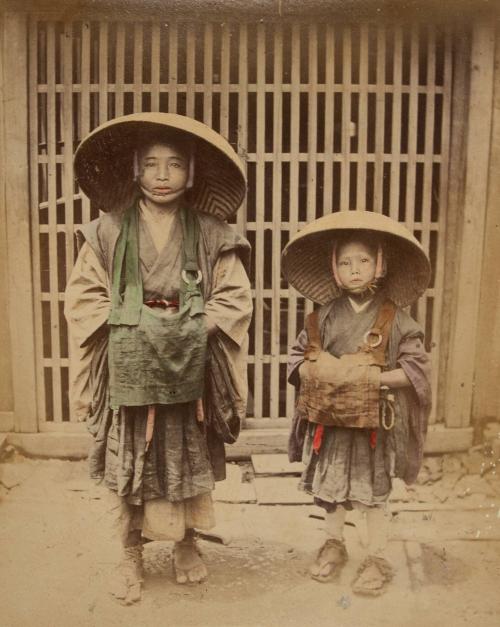 [Two peasants wearing hats]