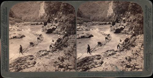 Exciting experience of men on a log-rift, shooting the Hozu Rapids on the Katsura, Kyoto, Japan 