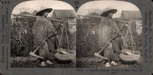 A Typical Japanese Farmer in Rain Coat and Hat