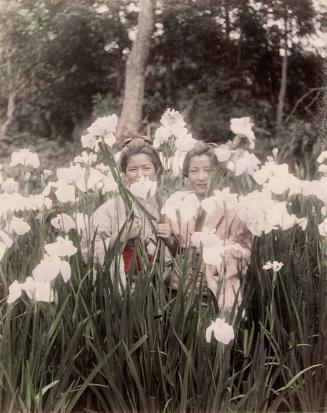 Two Young Girls Standing in Iris Field