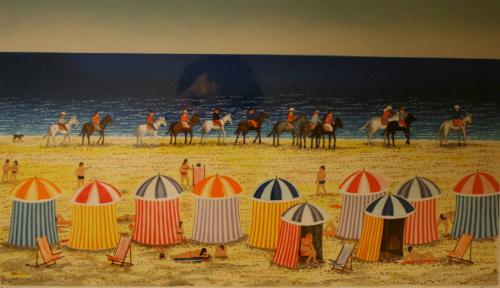 Beach scene with cabanas in foreground, horses in background