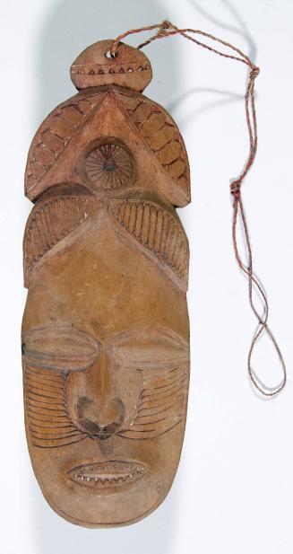 Carved Wood Amulet with Human Face