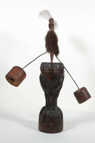 Standing Carved Figure Balanced Atop a Wooden Base by Two Weights (A & B)