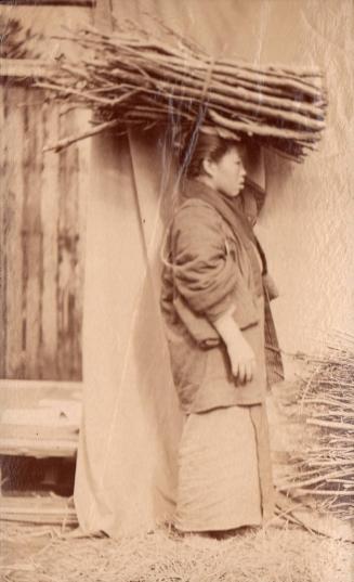 Woman Carrying Wood on Her Head