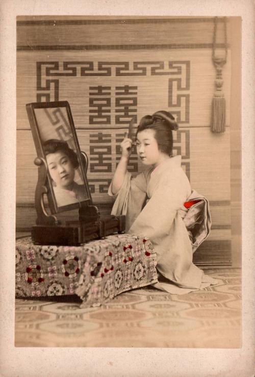 [Woman at mirror]