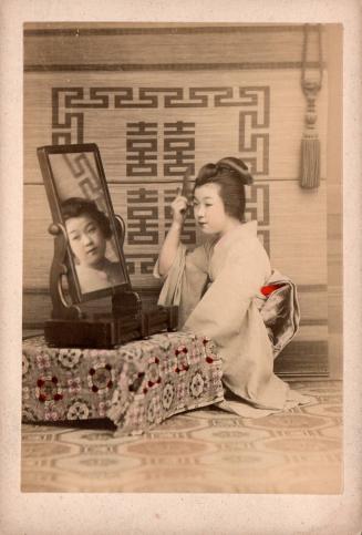 [Woman at mirror]