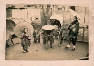 Riksha, child and a man with umbrellas