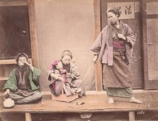 Three Women Playing with a Doll on Pull Cart