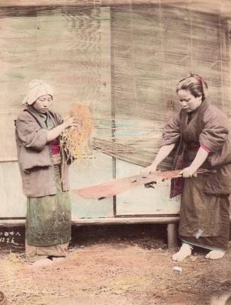 [Two women sorting rice]