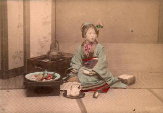 [Young girl in a kimono sitting next to a platter of Sushi]
