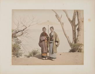 Two Women Standing Beneath an Umbrella