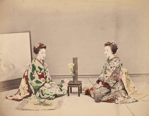 Two women arranging flowers