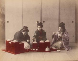Three women eating noodles