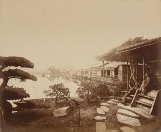 Houses on a waterway, woman on steps