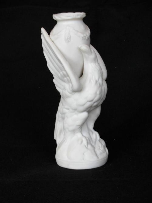 [Urn-shaped parian vase supported by eagle ornament with raised wings]