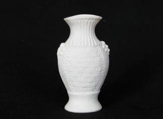 [Amphora-shaped woven basket pattern parian vase with flared lip, low relief fluting on neck, and applied berry clusters on shoulder]