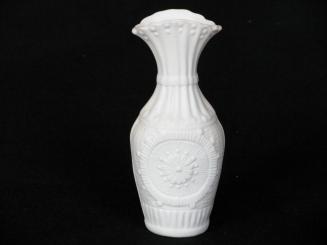 [Parian vase with flared scalloped lip, reeding on neck radiating floral motif on body with background mottling and fluting around base]