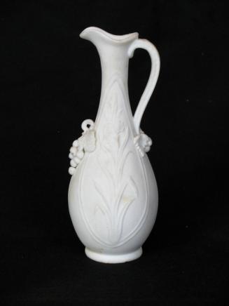 [Pear-shaped parian ewer with applied grape clusters at base of neck and handle, high relief floral decoration with background mottling]