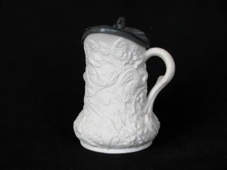 [Squat-bodied parian syrup pitcher with side twig handle, hinged metal lid, interior glaze and hight relief bird, tree, and floral decoration]