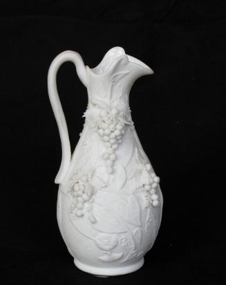 [Pear-shaped morning glory pattern parian pitcher with interior glaze applied grape clusters on neck and body and background mottling]