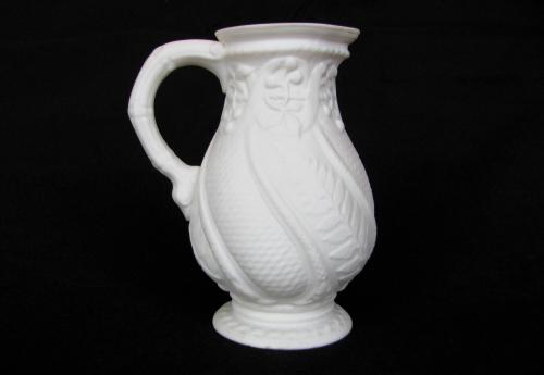 [Pear-shaped parian pitcher with segmented handle and interior glaze]