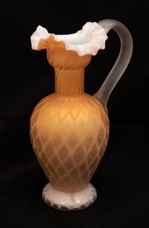 [Orange ewer with ruffled tricorn lip and clear handle]