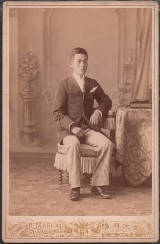 [Formal portrait of seated man in a suit]