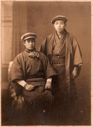 [Two Japanese men, one seated, the other standing]
