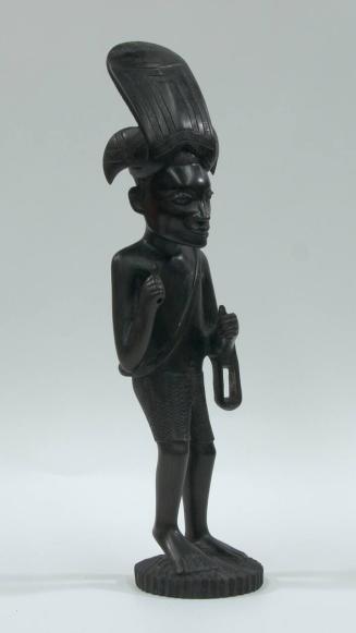 untitled [Makonde, male figure with 11 farm implements and weapons included]