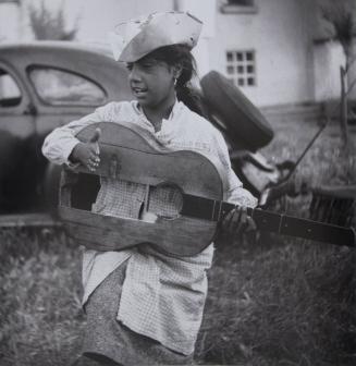 Young gypsy girl with broken guitar, Stes Maries de la Mer