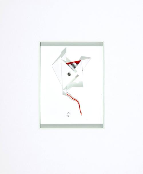 [White folded paper resembling a kite, with red string]
