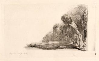 Nude man seated on the ground with one leg extended