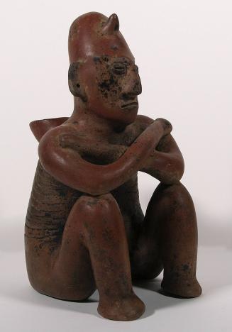 [Seated figure with incised ribs]