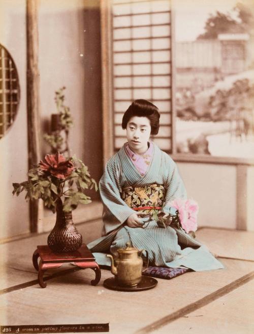 [Woman putting flowers in a vase]