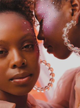 [Portrait of two young Black women wearing large hooped earrings]