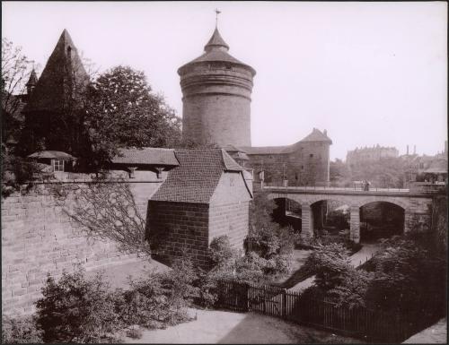 [Buildings with people on bridge]