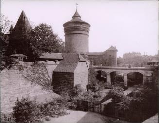 [Buildings with people on bridge]