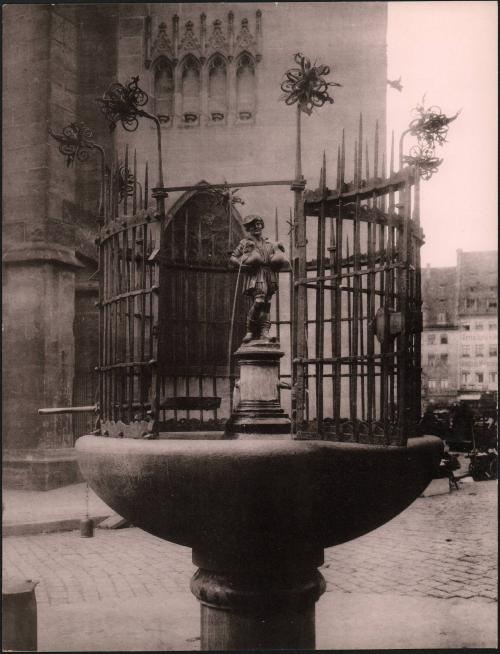 [Small fountain with figurine holding ducks]