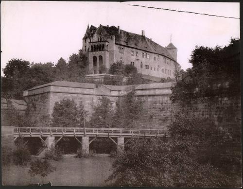 [Wall structure with building in background]