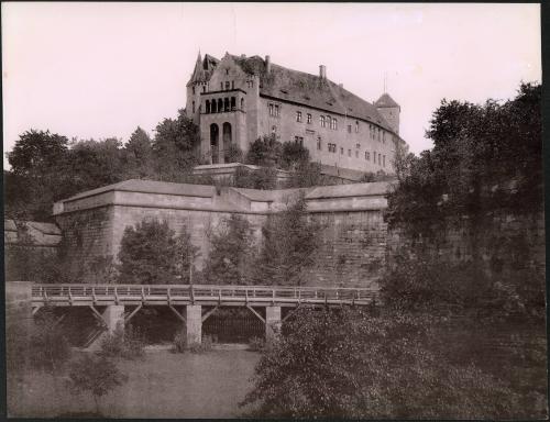 [Wall structure with building in background]