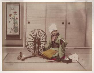 Woman spinning thread