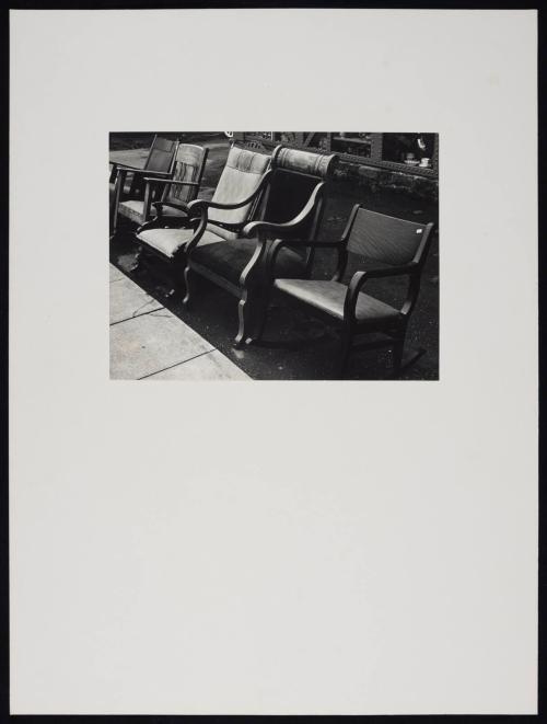 Chairs for sale lined up on sidewalk