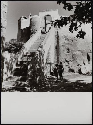 Women on staircase, children carrying wood, Italy