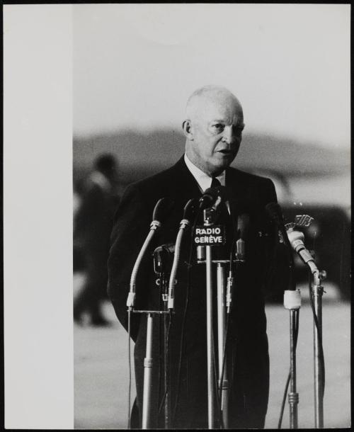 Dwight D. Eisenhower speaking into multiple microphones at the Geneva Conference