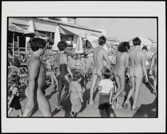 Family walking down pathway in nudist village, Cote d'Azur, France