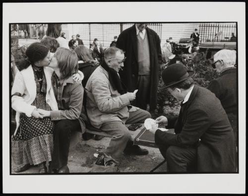 Couple kissing, men playing cards, Paris, France